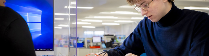 A student using a computer wiring board