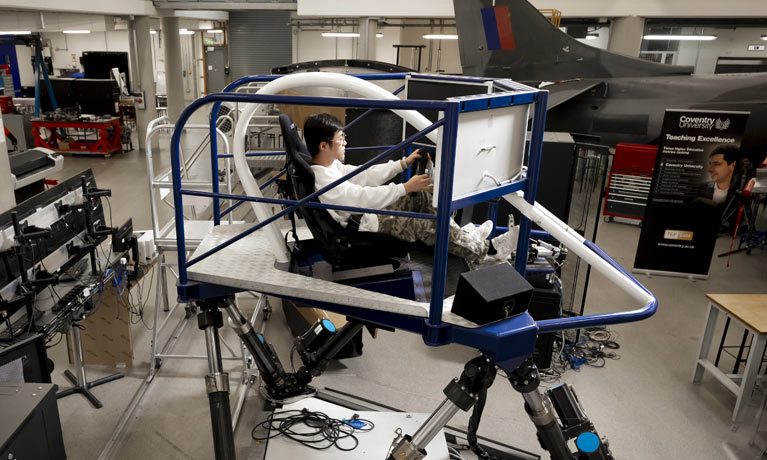 Overview of a male student in a model car 