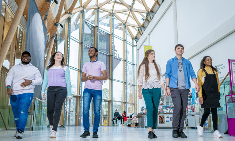 A group of students walking through the Herbert Art Gallery and Museum