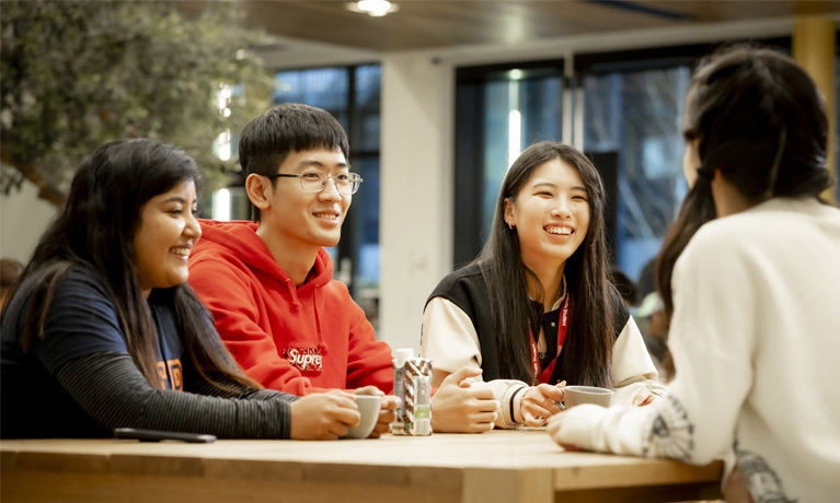 Group of students sat together talking