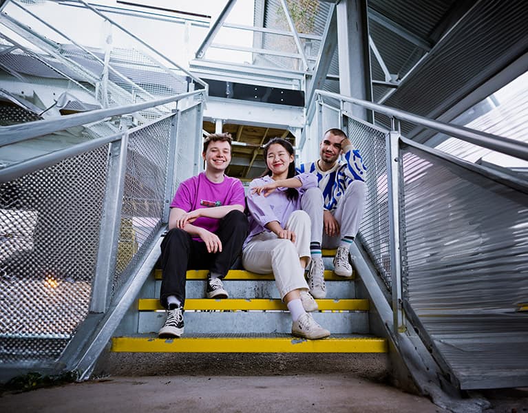 Group of students sat on some steps