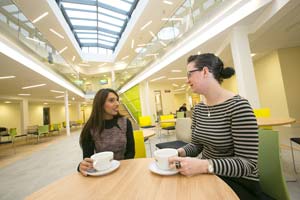 two females talking around a table