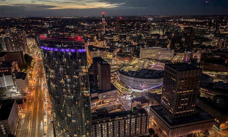 A city skyline at night time