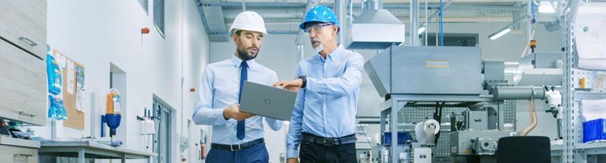 Two businessmen walking through a factory