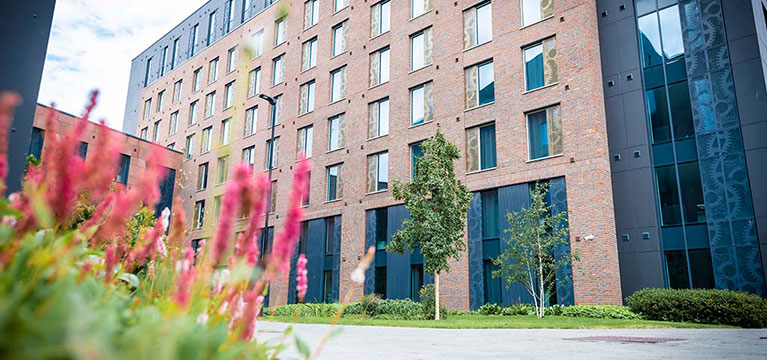 Outside of Godiva Place surrounded by flowers