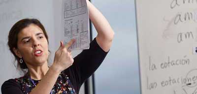 tutor holding up and pointing to a piece of paper