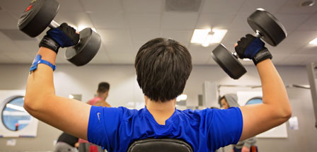 man in the gym working with weights