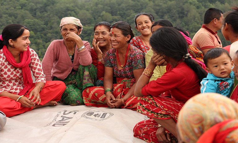 women wearing ethnic clothing sitting down in a circle