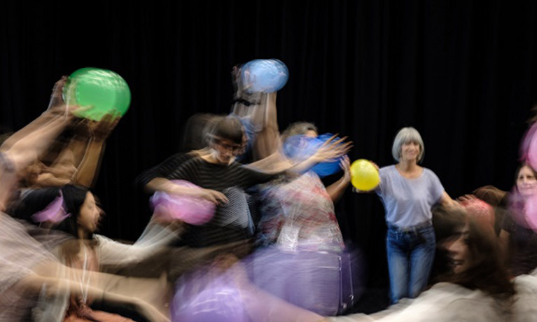 blurred photography of dance research using colourful objects and multiple people