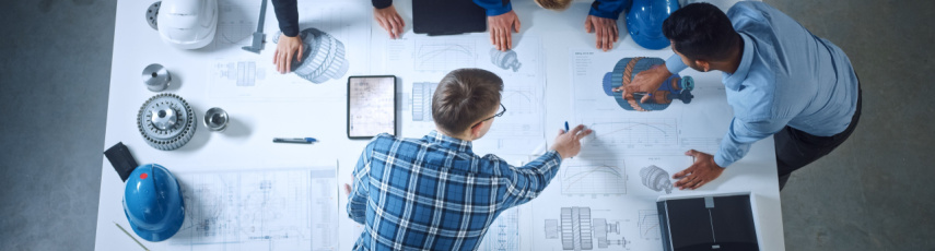 Team of Industrial Engineers Lean on Office Table, Analyze Machinery Blueprints, Architectural Problem Solving, Consult Project on Tablet Computer, Inspect Metal Component. Flat Lay Top Down View