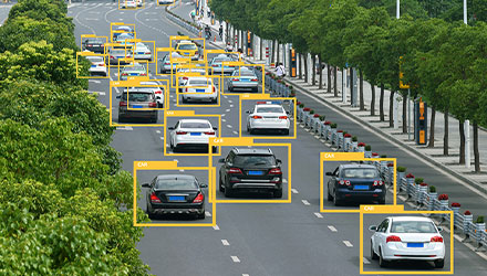 Cars on a road circled with yellow boxes