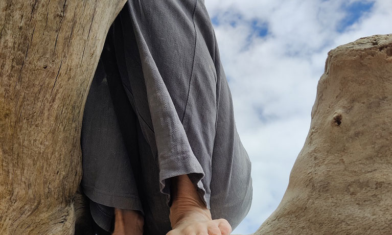 Someone sitting on a rock
