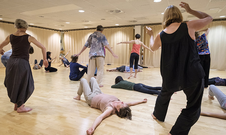 a group of people dancing in a dance studio