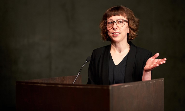 Professor Carolina Rito speaking in a stand