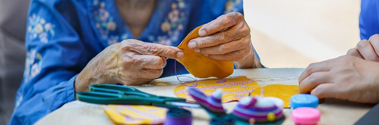 Woman doing needle work.