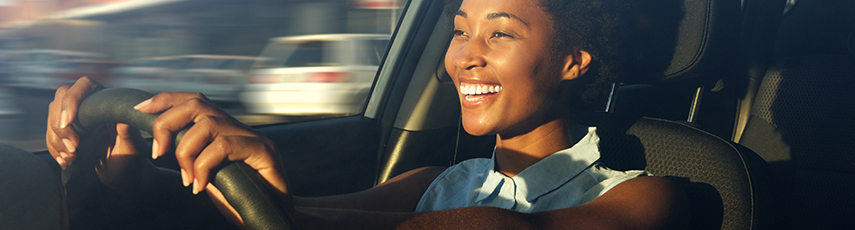 Young woman smiling while driving