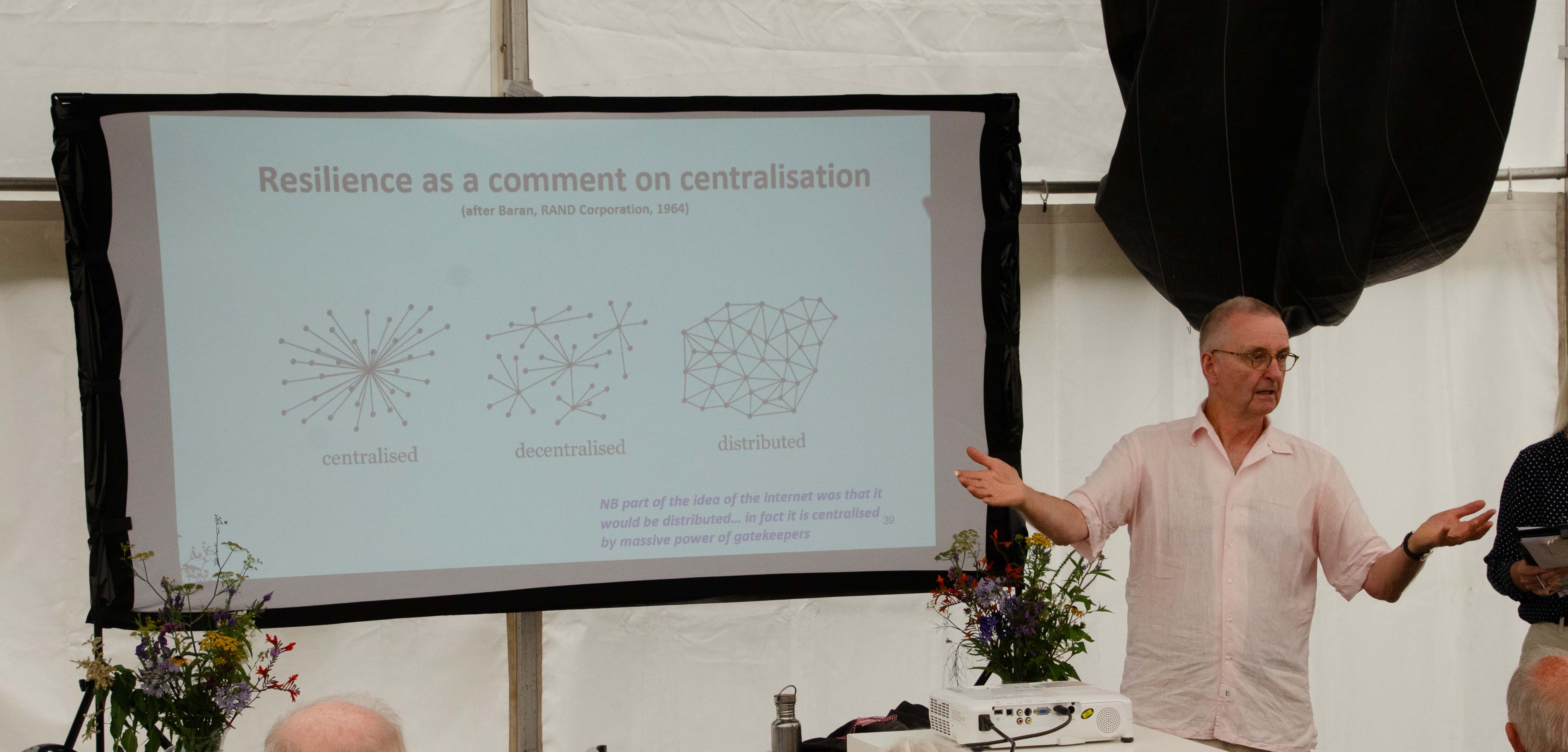 Prof Tim Lang presenting with his slides displayed to his right