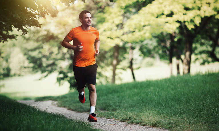 man running through park