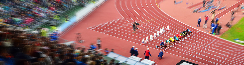 Professional athletes in stadium are on start blocks ready to race