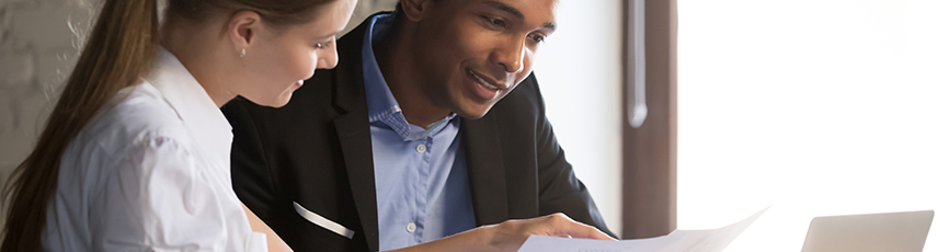 A man and a woman looking over a CV together