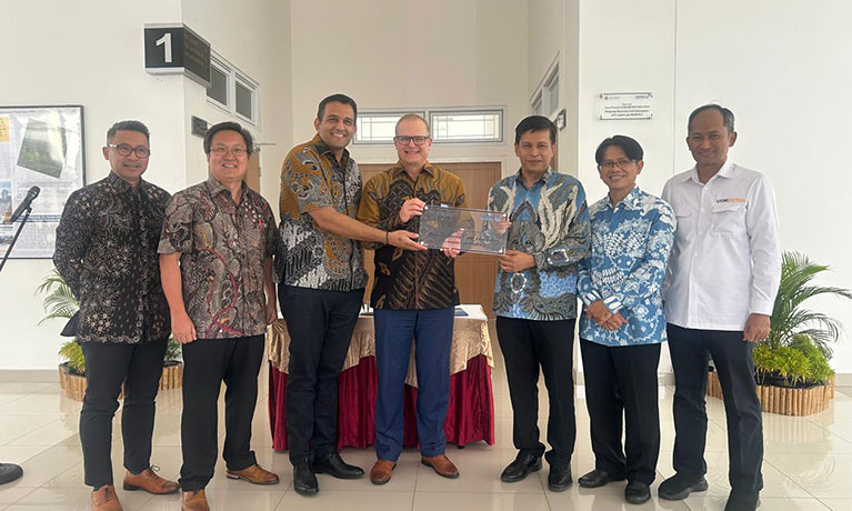 Richard Dashwood and Rohit Bhagat standing with Universitas Gadjah Mada employees