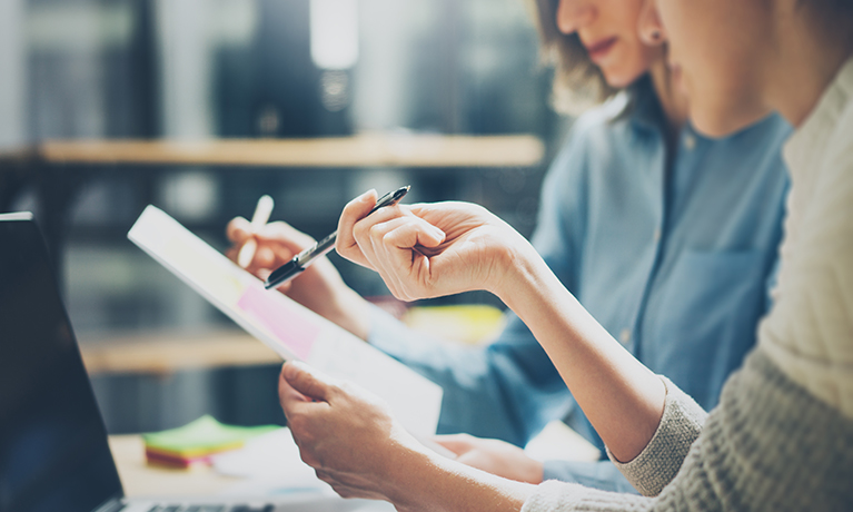 Two people looking at a document