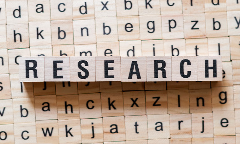 The word research written in wooden letters sat over various wooden letters