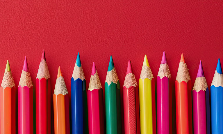 Coloured pencils on red background