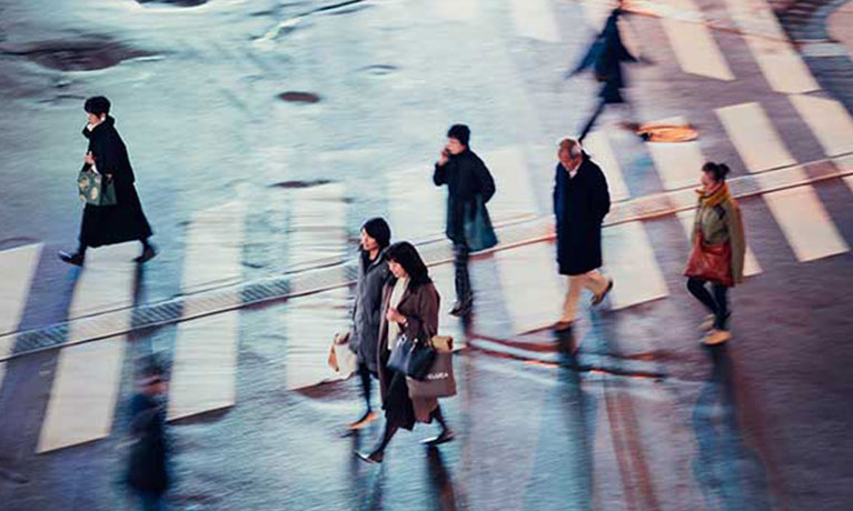 People walk across a street