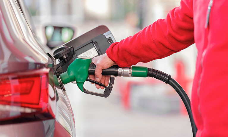 Person putting petrol in their car