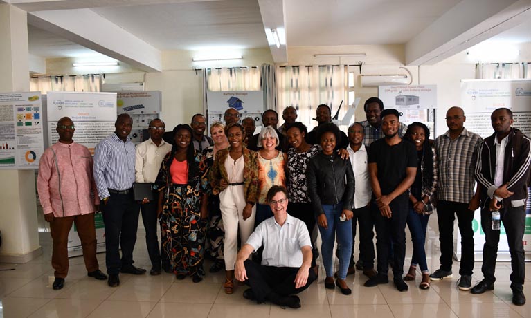 Group of attendees from Rwanda and Coventry Summer School smiling indoors