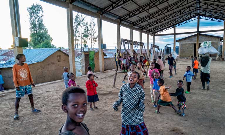 Young children playing in outdoor playground at Kigeme Refugee Camp, Rwanda.