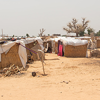 Refugee camp made of local materials and plastic sheeting