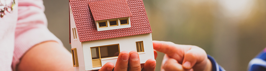 Child holding a toy house