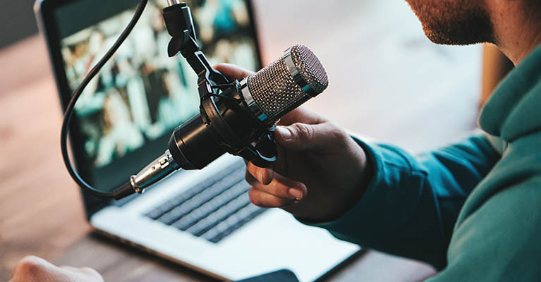 Man using a microphone with laptop