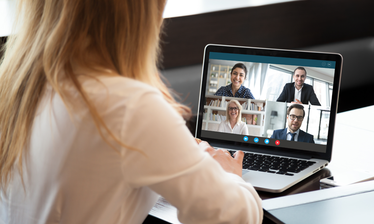 Woman taking part in an online split screen meeting