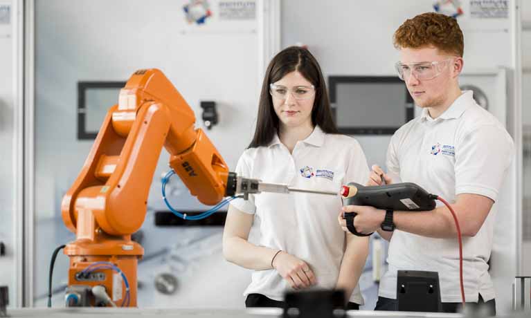 Two students looking at a piece of equipment