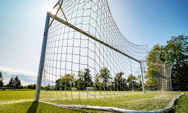 Back of football goal post on sunny day