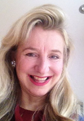 close up portrait of Juliet Simpson smiling with a white background