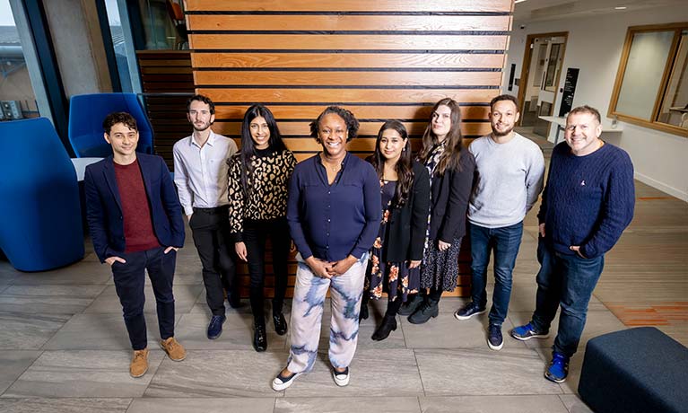 Group of staff standing together and smiling