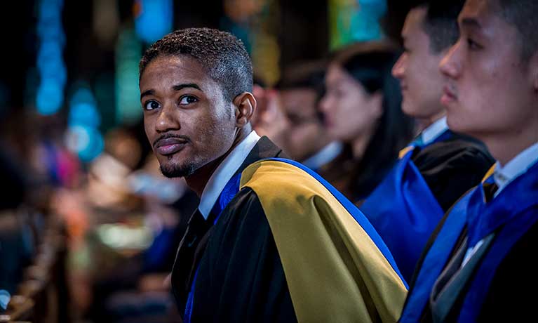 male asian student at graduation