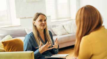 Two women in discussion in smart dress