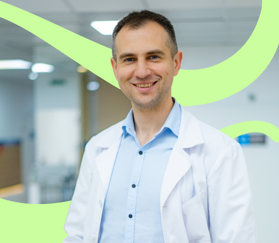 Man in labcoat smiles, with green wavy lines overlaid.