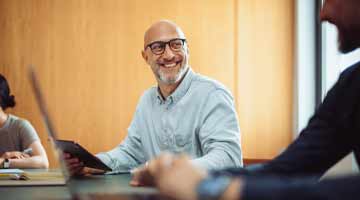 Man with tablet in his hand smiling
