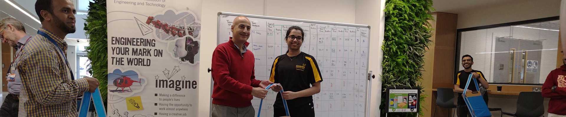 Sri Anshula being presented with a bag in the university