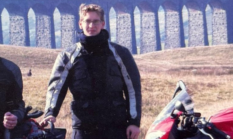 Gavin Hardman smiling infront of fields