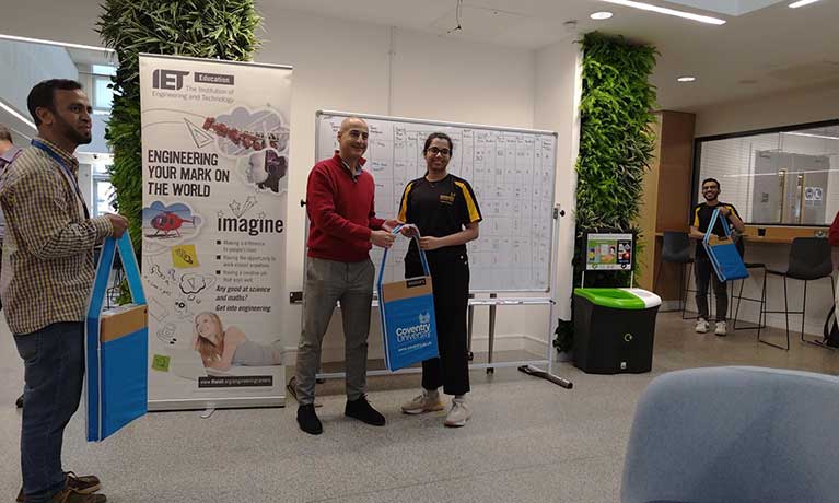 Sri being presented with a bag Sri being presented with a bag at a presentation