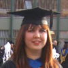 Emilie smiling in a graduation cap