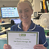 Zoe Faulconbridge holding a certificate and smiling
