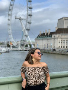 girl standing outside with the London eye in the background